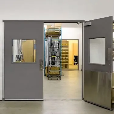 Gray double doors with vision panels, kick plates, and door closers