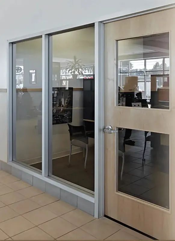 Aluminum-framed glass entrance and sidelites opening into an office