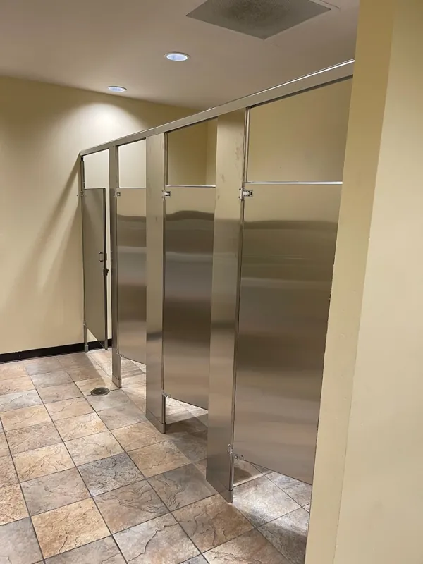 Metal restroom compartments with matching doors and hardware